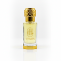 Perfume bottle labeled 'Oud Al Amal' with gold cap and clear body on a white background