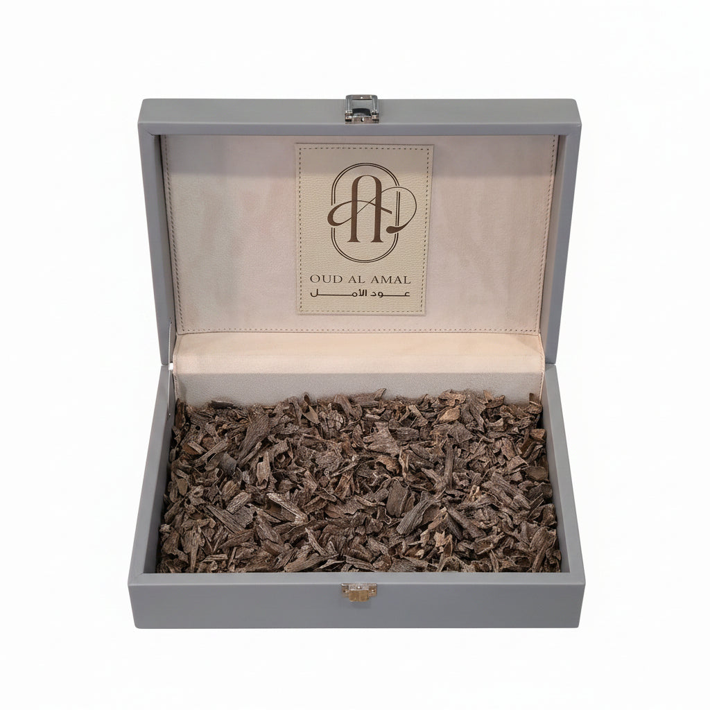 Gray box with Oud Al Amal oudwood inside on a white background